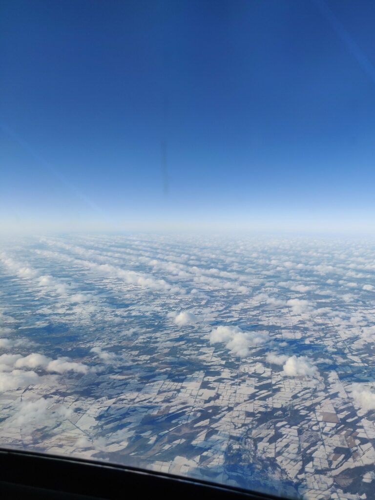 Photo of lines of clouds from the air looking down.