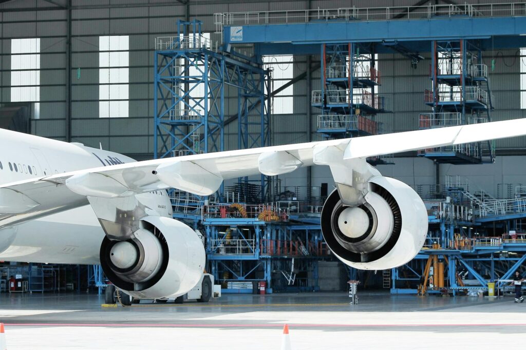 details of contemporary airplane in hangar in sunlight